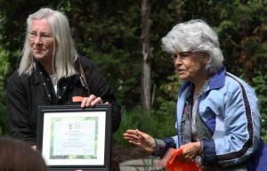 Lis Allison, creator of the Bill Cody Fern Trail, receiving special thanks from Isabelle Nicol, head of the Backyard Garden